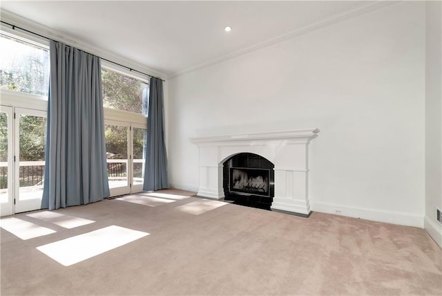 unfurnished living room featuring a tiled fireplace, baseboards, carpet, and ornamental molding