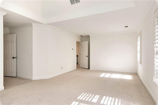 carpeted empty room with visible vents, baseboards, and ornamental molding