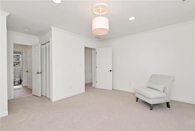 sitting room featuring ornamental molding, baseboards, and carpet floors