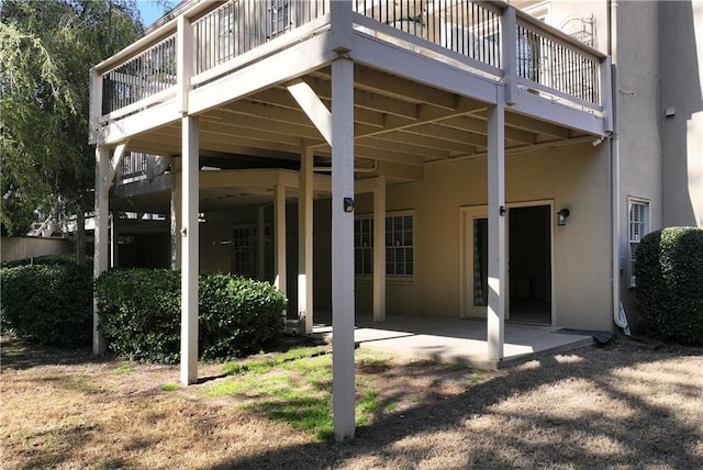 back of house featuring stucco siding and a patio