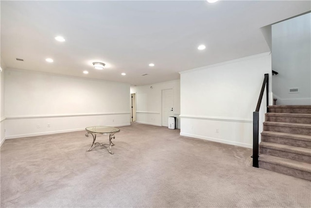 below grade area featuring stairway, baseboards, crown molding, and carpet