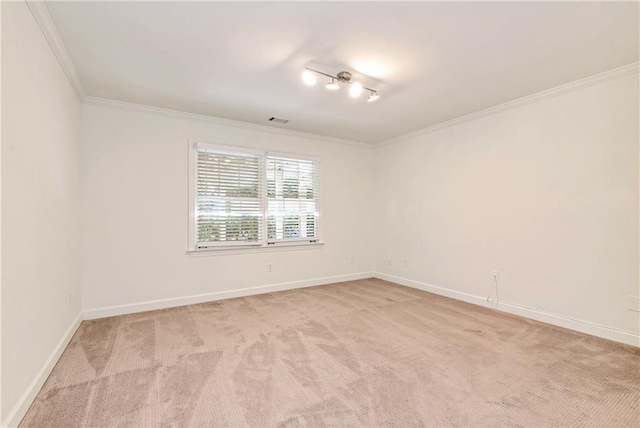 unfurnished room featuring visible vents, light colored carpet, baseboards, and ornamental molding