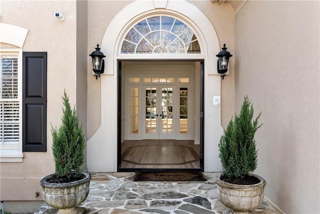 entrance to property with stucco siding and french doors