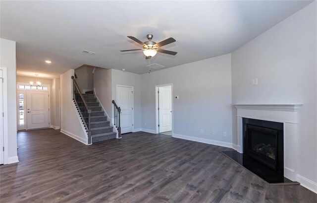 653 Forest Way, Cornelia, GA 30531 - unfurnished living room with stairway, baseboards, dark wood-type flooring, a fireplace with raised hearth, and a ceiling fan