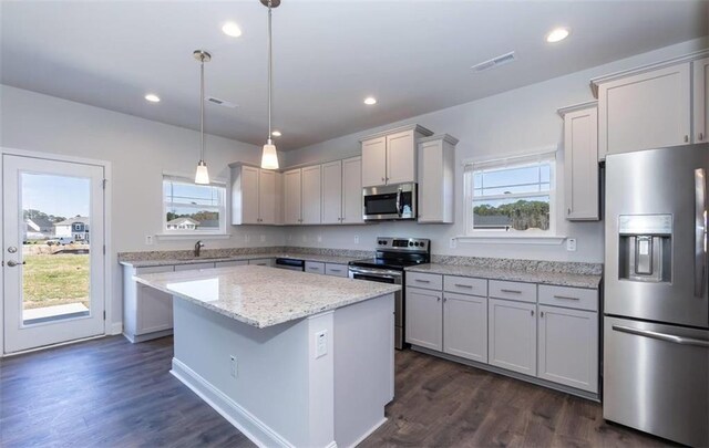 653 Forest Way, Cornelia, GA 30531 - kitchen with stainless steel appliances, a sink, a kitchen island, dark wood-type flooring, and decorative light fixtures