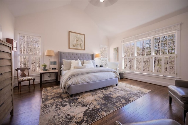 bedroom featuring dark wood-type flooring and high vaulted ceiling