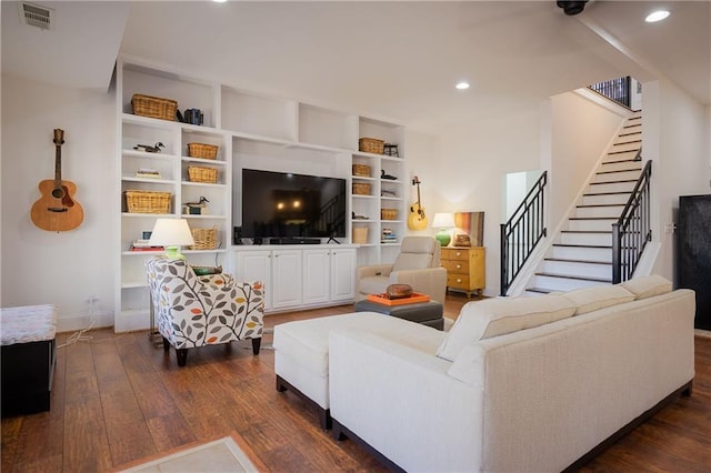 living area featuring stairs, dark wood finished floors, visible vents, and recessed lighting