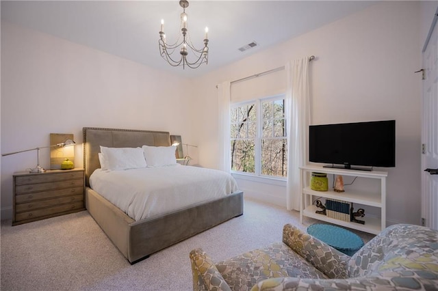 carpeted bedroom with visible vents and a notable chandelier