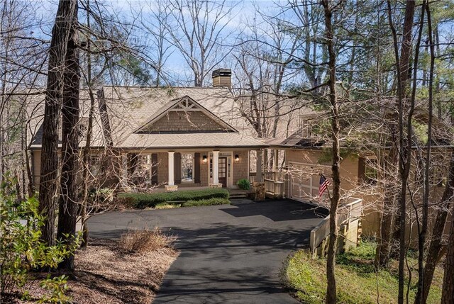 view of front of property featuring driveway and a chimney