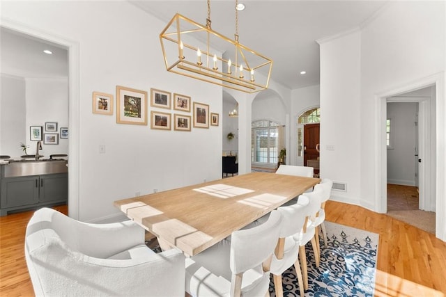 dining space with light hardwood / wood-style flooring and sink