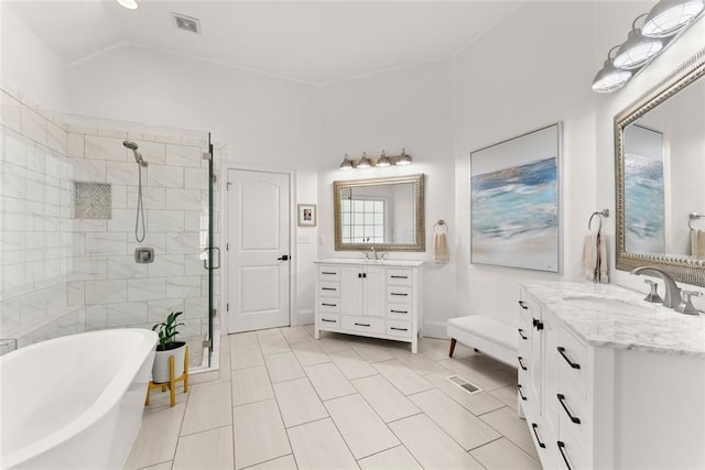 bathroom with tile patterned flooring, shower with separate bathtub, and vanity