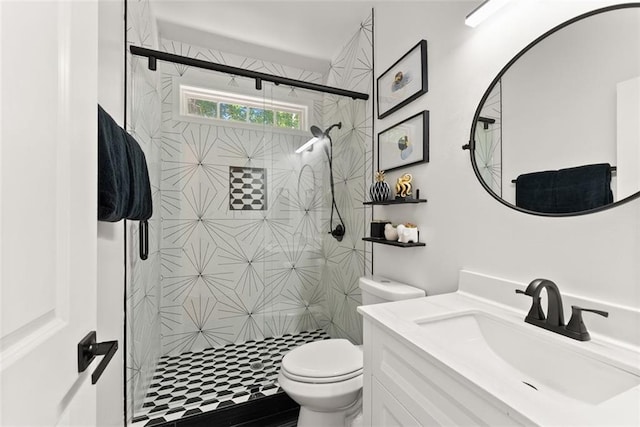 bathroom with an enclosed shower, vanity, and toilet