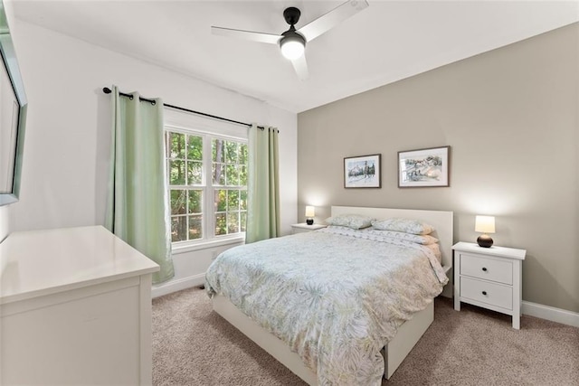 bedroom with ceiling fan and light carpet