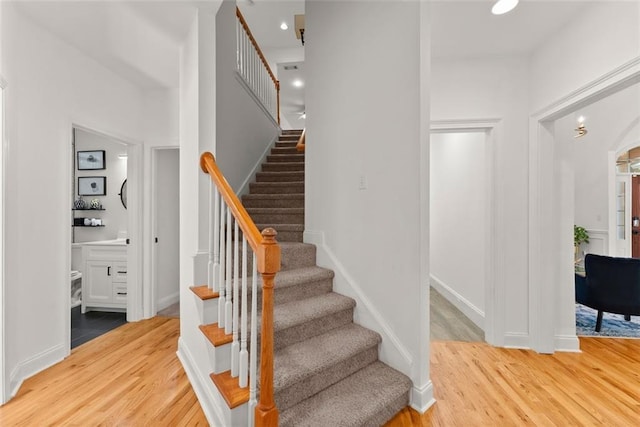 stairway with hardwood / wood-style floors