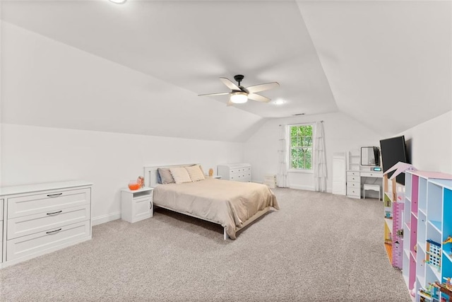 bedroom with ceiling fan, light colored carpet, and vaulted ceiling