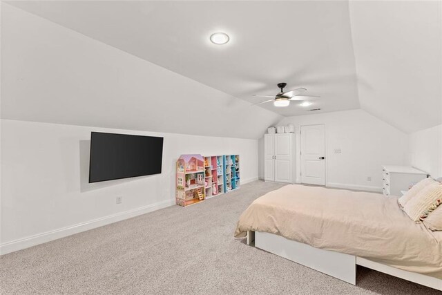 carpeted bedroom with ceiling fan and lofted ceiling