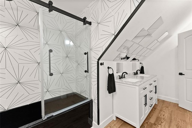 bathroom featuring a shower, vanity, and wood-type flooring