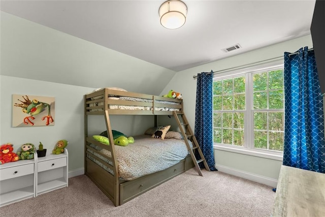 bedroom featuring light carpet, multiple windows, and lofted ceiling