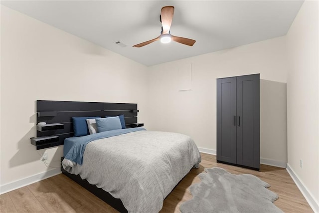 bedroom with wood-type flooring and ceiling fan