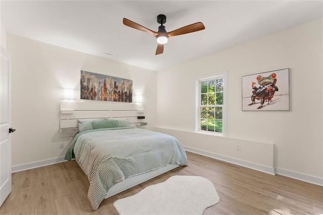 bedroom with ceiling fan and light wood-type flooring