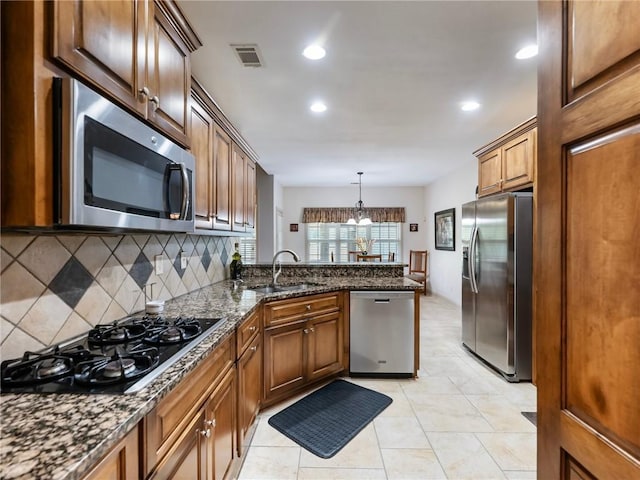 11 Stillwater Way, Hoschton, GA 30548 - kitchen with appliances with stainless steel finishes, backsplash, a peninsula, recessed lighting, and dark stone counters