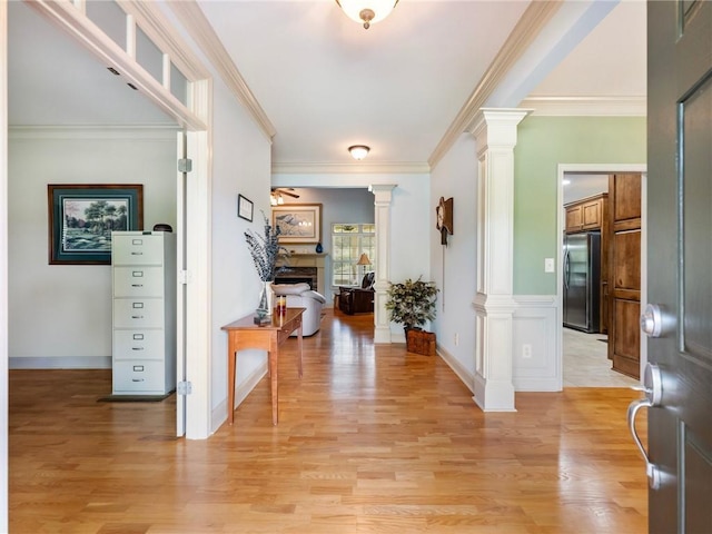 11 Stillwater Way, Hoschton, GA 30548 - entrance foyer featuring decorative columns, light wood-type flooring, a fireplace, and crown molding