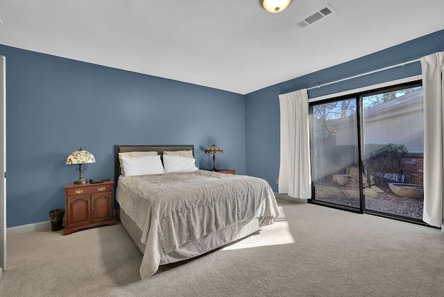 bedroom featuring access to exterior and light colored carpet