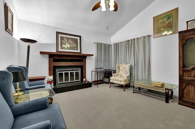 living room featuring carpet flooring, vaulted ceiling, ceiling fan, and a tiled fireplace