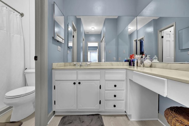 bathroom featuring hardwood / wood-style flooring, vanity, toilet, and a shower with shower curtain