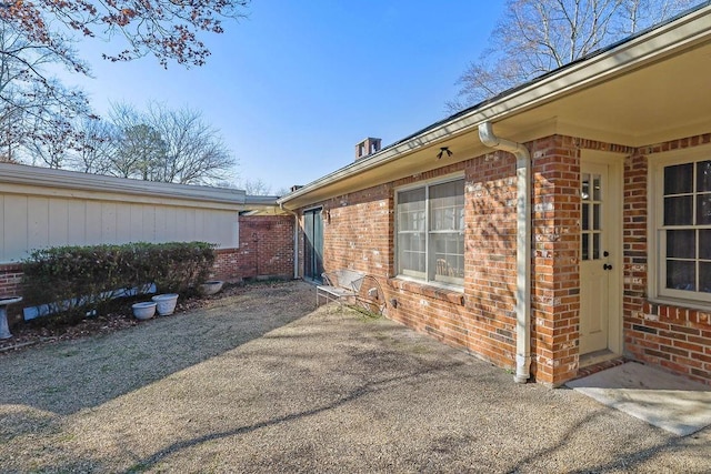 view of side of home with a patio area