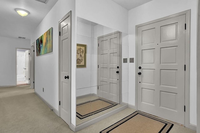 foyer with light colored carpet