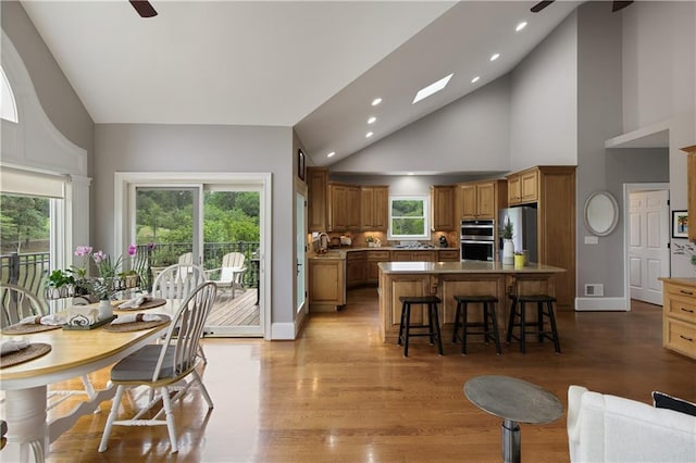 2675 Portabella Ln, Cumming, GA 30041 - dining room with a ceiling fan, high vaulted ceiling, recessed lighting, light wood finished floors, and baseboards