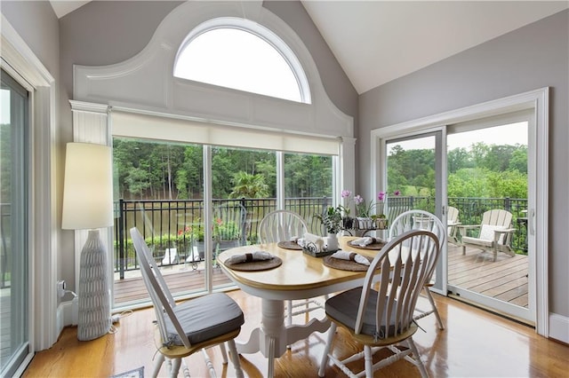 2675 Portabella Ln, Cumming, GA 30041 - dining space featuring high vaulted ceiling and light wood-style floors