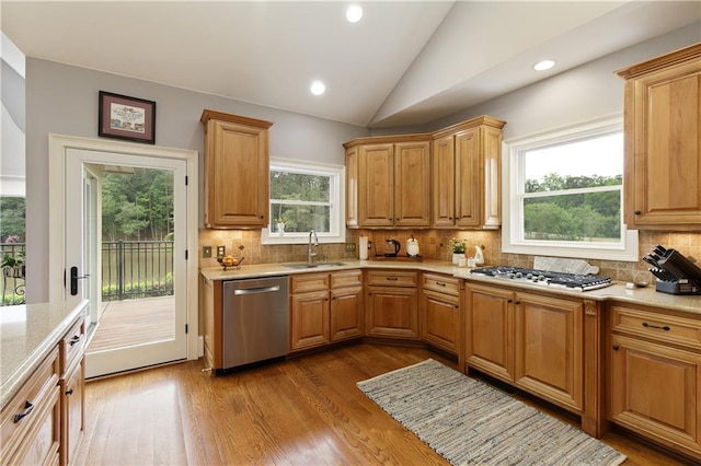2675 Portabella Ln, Cumming, GA 30041 - kitchen featuring dishwasher, a sink, gas cooktop, lofted ceiling, and wood finished floors
