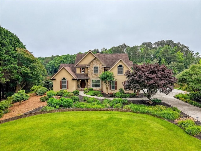 2675 Portabella Ln, Cumming, GA 30041 - traditional-style house with stucco siding, stone siding, a front yard, and a chimney