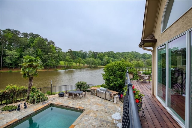 2675 Portabella Ln, Cumming, GA 30041 - view of pool with a fenced backyard, a patio area, a view of trees, and a deck with water view