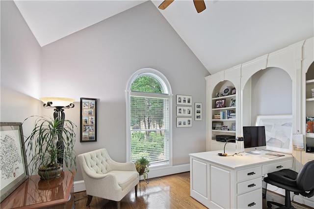 2675 Portabella Ln, Cumming, GA 30041 - home office featuring high vaulted ceiling, a ceiling fan, light wood finished floors, built in features, and baseboards