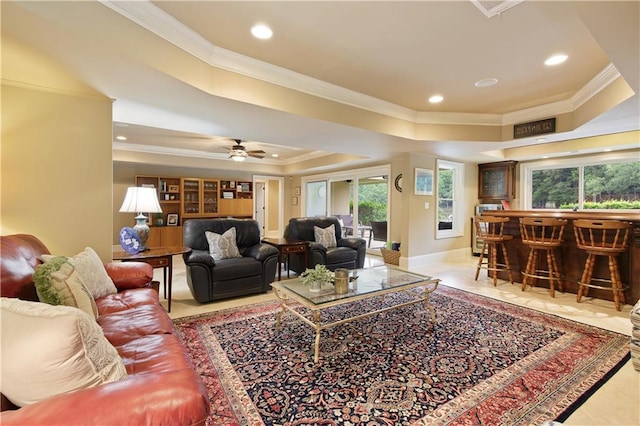 2675 Portabella Ln, Cumming, GA 30041 - living area featuring a tray ceiling, crown molding, a bar, ceiling fan, and recessed lighting