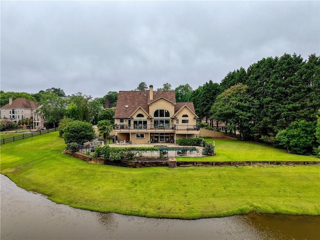 2675 Portabella Ln, Cumming, GA 30041 - back of property with a water view, an outdoor pool, a patio area, and a chimney
