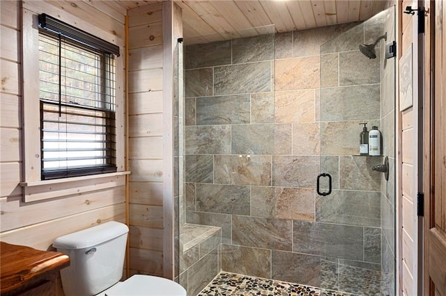 bathroom featuring a shower with shower door, wooden ceiling, toilet, and wood walls