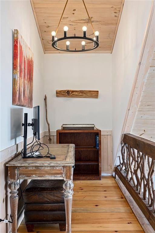 office area with light wood-type flooring, wooden ceiling, and a chandelier