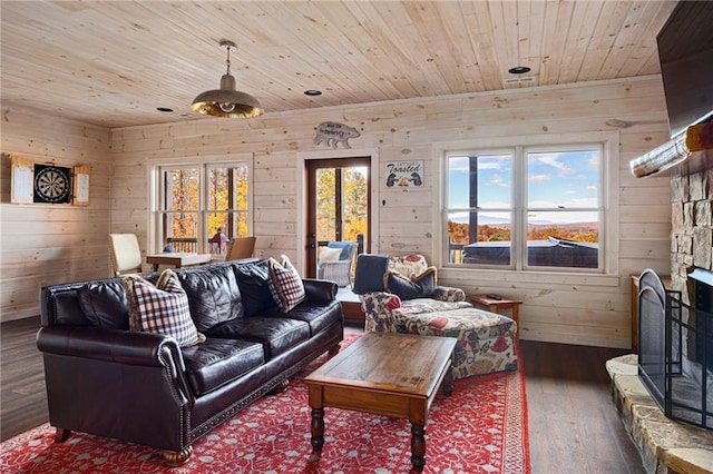 living room with wooden walls, a fireplace, hardwood / wood-style flooring, and wooden ceiling