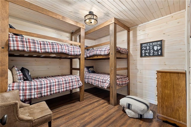 bedroom featuring wooden ceiling, dark wood-type flooring, and wooden walls