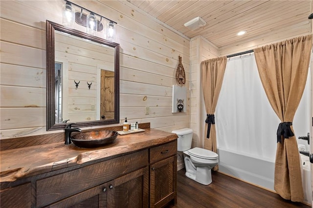 full bathroom featuring hardwood / wood-style flooring, wooden walls, and vanity