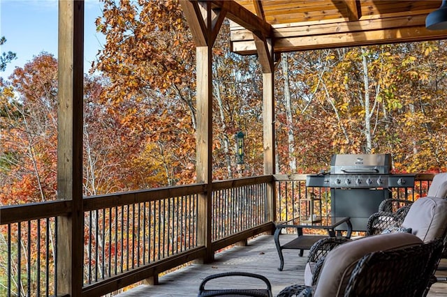 wooden deck featuring a grill