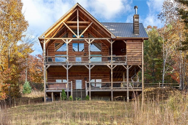 back of property with a balcony