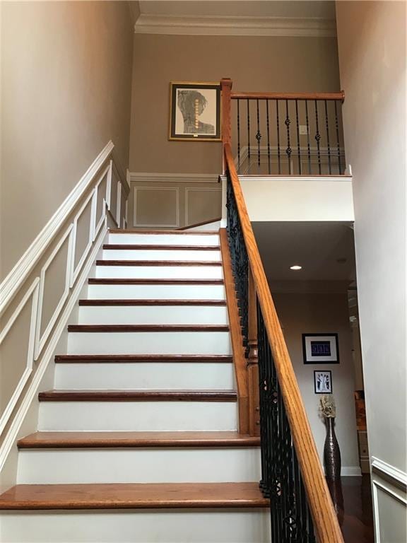 1175 Grassy Oat Ln, Lawrenceville, GA 30045 - stairway featuring ornamental molding, a wainscoted wall, and a decorative wall