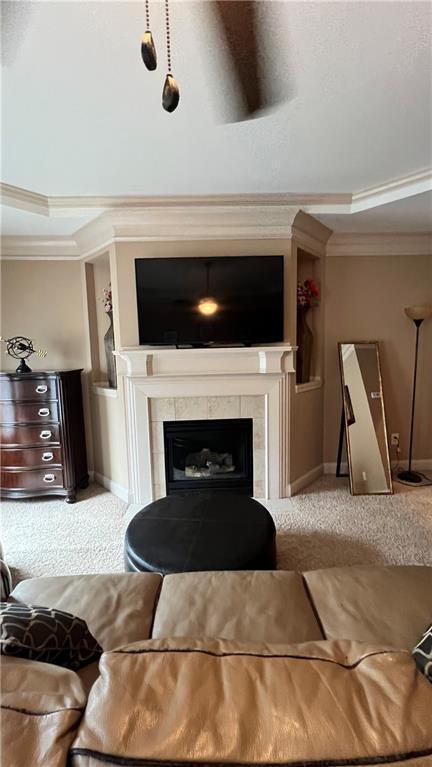 1175 Grassy Oat Ln, Lawrenceville, GA 30045 - living room featuring crown molding, carpet floors, and a tile fireplace