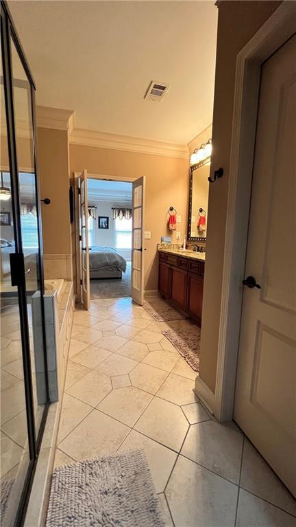 1175 Grassy Oat Ln, Lawrenceville, GA 30045 - ensuite bathroom featuring crown molding, vanity, and tile patterned flooring