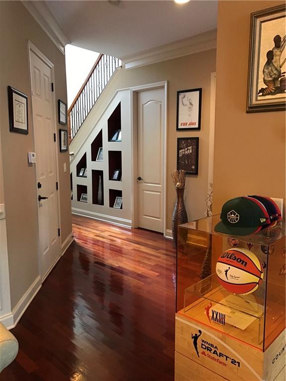 1175 Grassy Oat Ln, Lawrenceville, GA 30045 - hallway featuring ornamental molding and wood finished floors